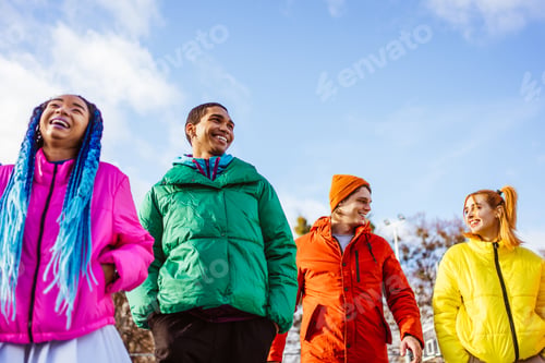 Preview: Multiracial group of young friends meeting outdoors in winter