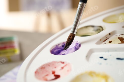 Preview: Paintbrush Mixing Purple Paint on a Palette