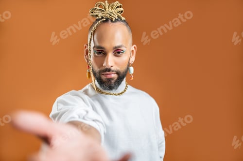 Preview: Black latin gay man outstretching empty hand towards camera