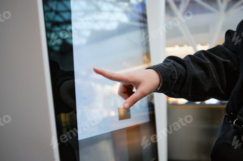 Preview: Woman Using Touchscreen Directory in Mall