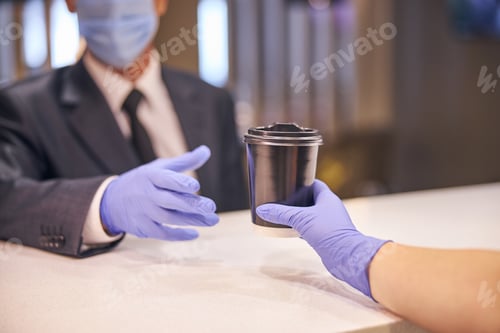 Preview: Businessman buying cup of drink during quarantine