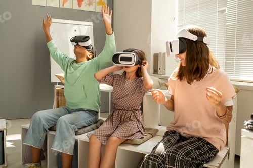 Preview: Three intercultural schoolgirls watching virtual presentation