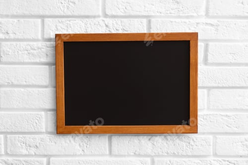 Preview: One blank small blackboard on white brick wall