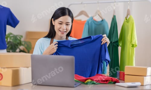 Preview: Portrait young attractive hipster asia female owner startup work happy with box at home prepare