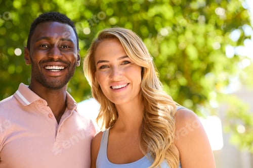 Vista previa: Close Up Portrait Of Loving Multi-Racial Couple Or Friends Hugging Outdoors In Countryside Together