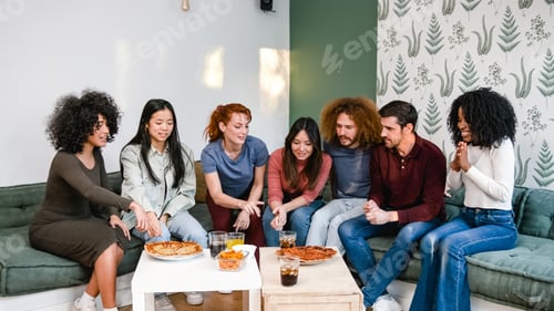 Preview: Multiethnic friends discussing over delicious pizzas in living room during weekend party