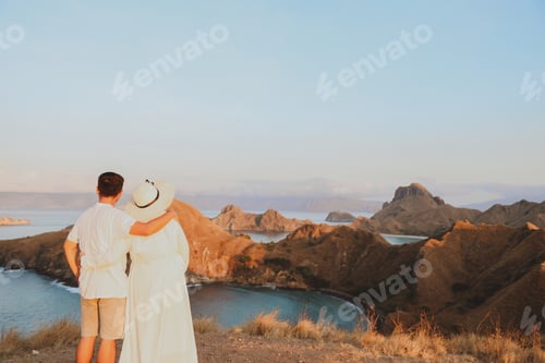 Preview: Couple enjoying nature view on sunset