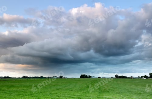 Preview: shower cloud over green meadow