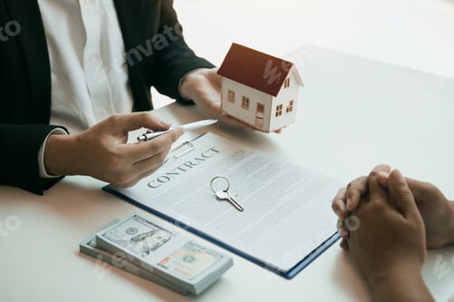 Preview: New home buyers are signing a home purchase contract at the agent's desk.
