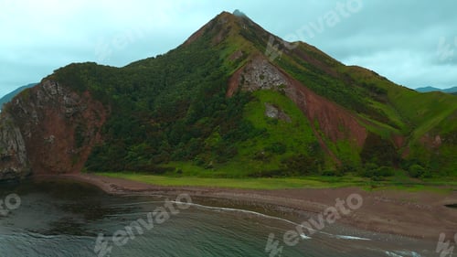 Preview: Top view of wild coast with rocky mountains. Clip. Flock of seagulls on ocean shore on backdrop of