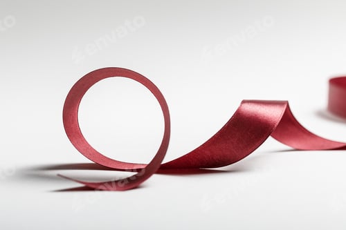 Preview: silk curved burgundy ribbon on grey background