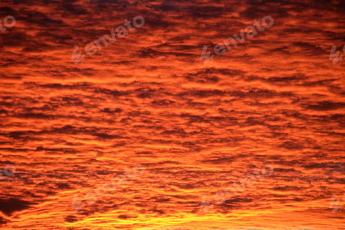 Preview: Bright colorful sunset sky with vivid smooth clouds illuminated