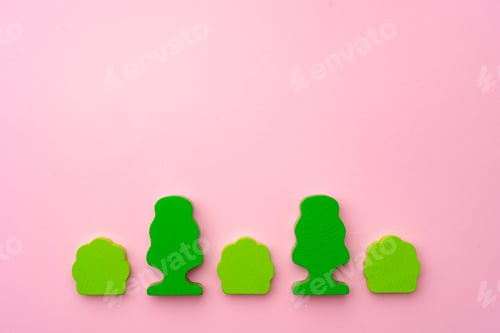 Preview: Wooden toy trees and bushes on pink paper background