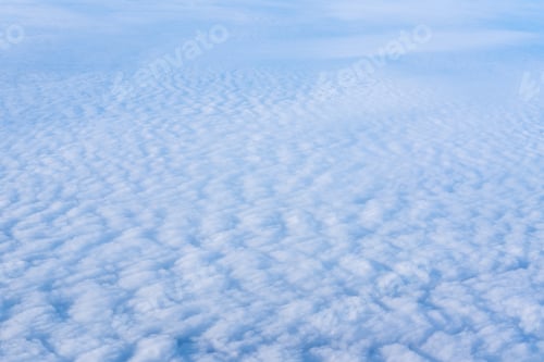 Preview: The view from the plane window of dense curly clouds and the blue stratosphere. Cloudscape