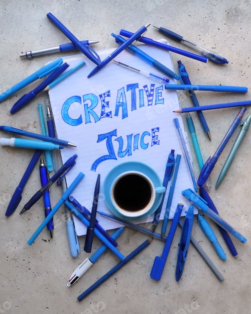 Preview: Creative juice, words with coffee and blue stationery on stone table