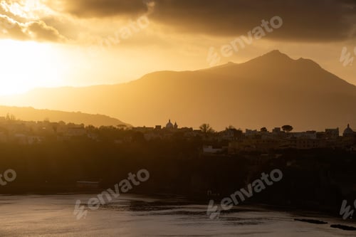 Preview: Houses of Procida in magic sunset with the island of Ischia in the background.