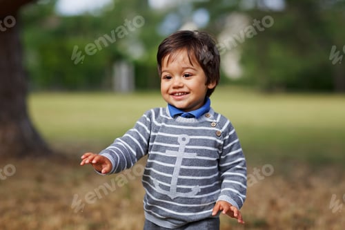 Preview: Portrait of a little eastern handsome baby boy playing outdoor in the park