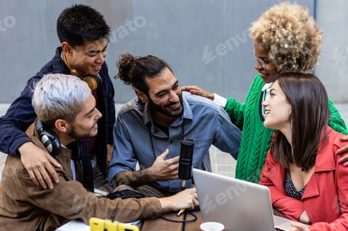 Preview: Multiracial diverse student friends doing homework together while using laptop