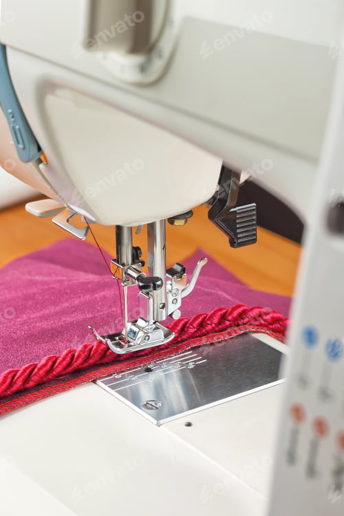 Preview: Modern sewing machine presser foot and decorative edging cord. Sewing process.