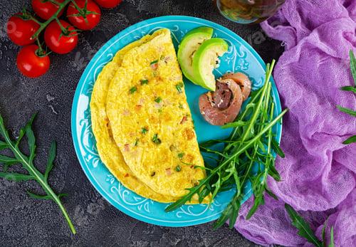 Preview: Fried omelette with ham, onion and herbs. Breakfast with scrambled eggs