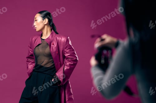 Preview: Fashion asian women in purple leather jacket taking photo of another woman in black outfit against
