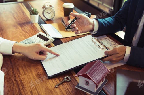 Preview: Home agents are explain to customers signing a contract to buy a new home.