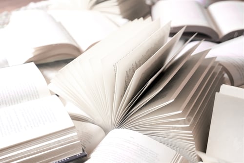 Preview: stack of books, close up. Open book on the table in library. Back to school concept.