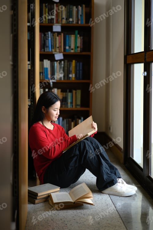 Preview: High school student girl reading book at library