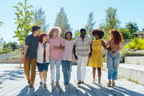 Preview: Multiethnic group of young friends meeting and having fun outdoors