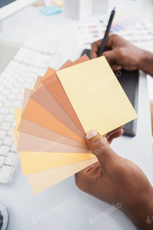 Preview: Designer working with digitizer and colour sample in the office