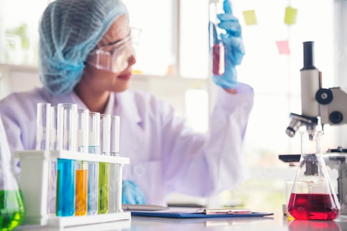Preview: Woman scientist in lab look at science microscope medical test and research biology chemistry