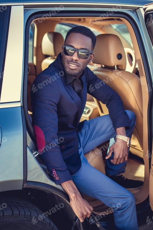 Preview: African american male posing in a car.