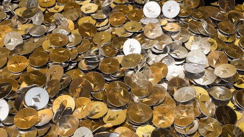 Preview: Cryptocurrency Ethereum golden coins spilling on the table