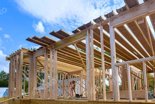 Preview: Construction work in progress viewing an unfinished house with wooden framing beams