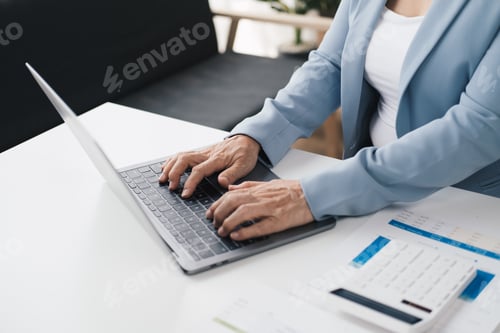 Preview: Close up view of old businesswoam working with laptop computer in the office room.