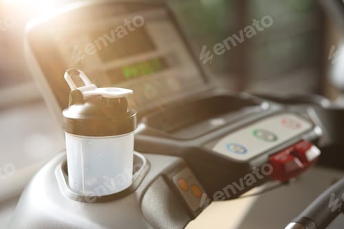 Preview: For your comfort. Digital screen of a treadmill and protein shaker standing on it. Copy space
