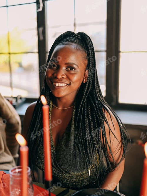 Preview: Beautiful young black woman portrait on the friends indoors party Christmas winter holiday dinner