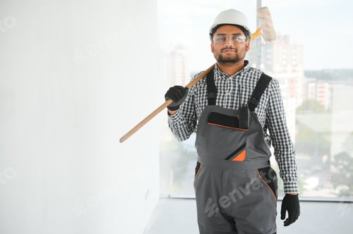 Preview: Indian Painter painting the office wall with roller paint