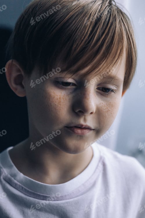Preview: Portrait redhead freckled boy, close-up. Expressive facial emotions. Selective focus