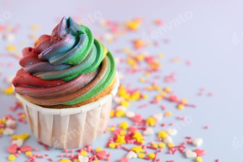 Preview: Colorful Frosted Cupcake with Sprinkles on Light Blue
