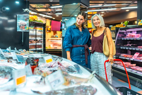Preview: Women shopping for fresh seafood in supermarket