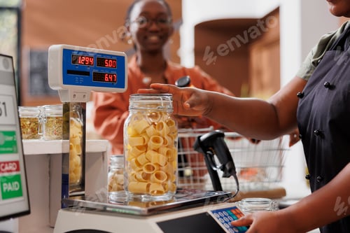 Preview: Seller measures jar filled with pasta