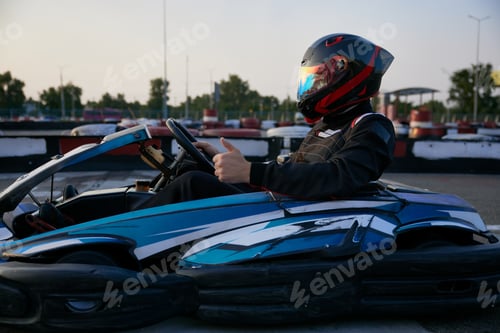 Preview: Helmeted Driver in Racing Kart Gives Thumbs Up