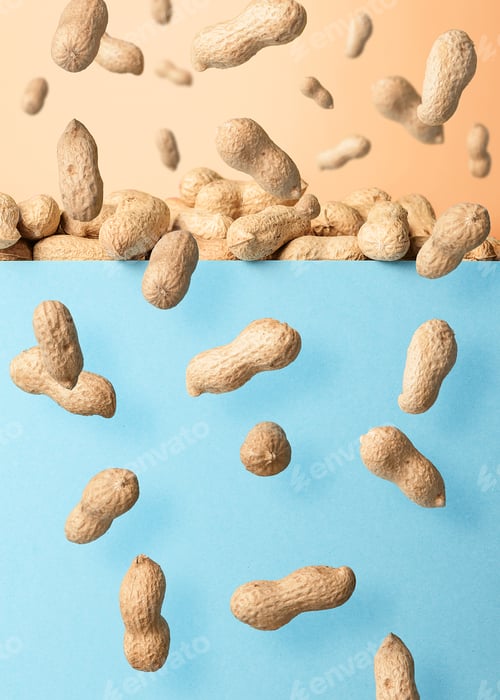 Preview: Levitation of unclean peanuts on blue background.