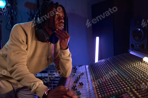 Preview: Man Adjusting Sound Levels in Recording Studio