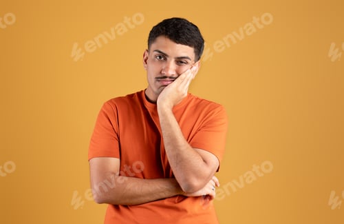 Preview: Portrait of brazilian man feeling bored, leaning on his hand, having dull day, showing lack of