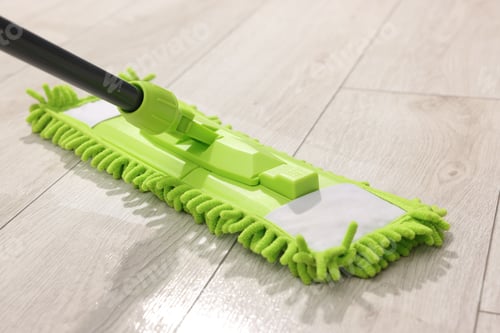 Preview: Microfiber mop on wooden floor, closeup. Cleaning equipment