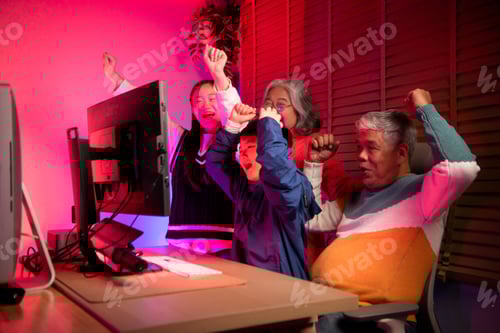 Preview: Happy grandparents playing games with grandchildren in in a neon lit room