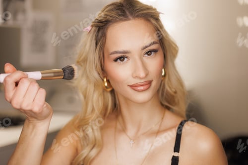 Preview: Glam beautiful blonde woman artist with clear skin face in beauty studio. Pretty fashion lady