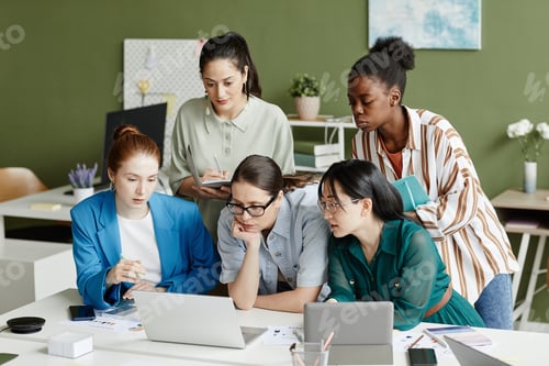 Preview: Group of women using laptop at work